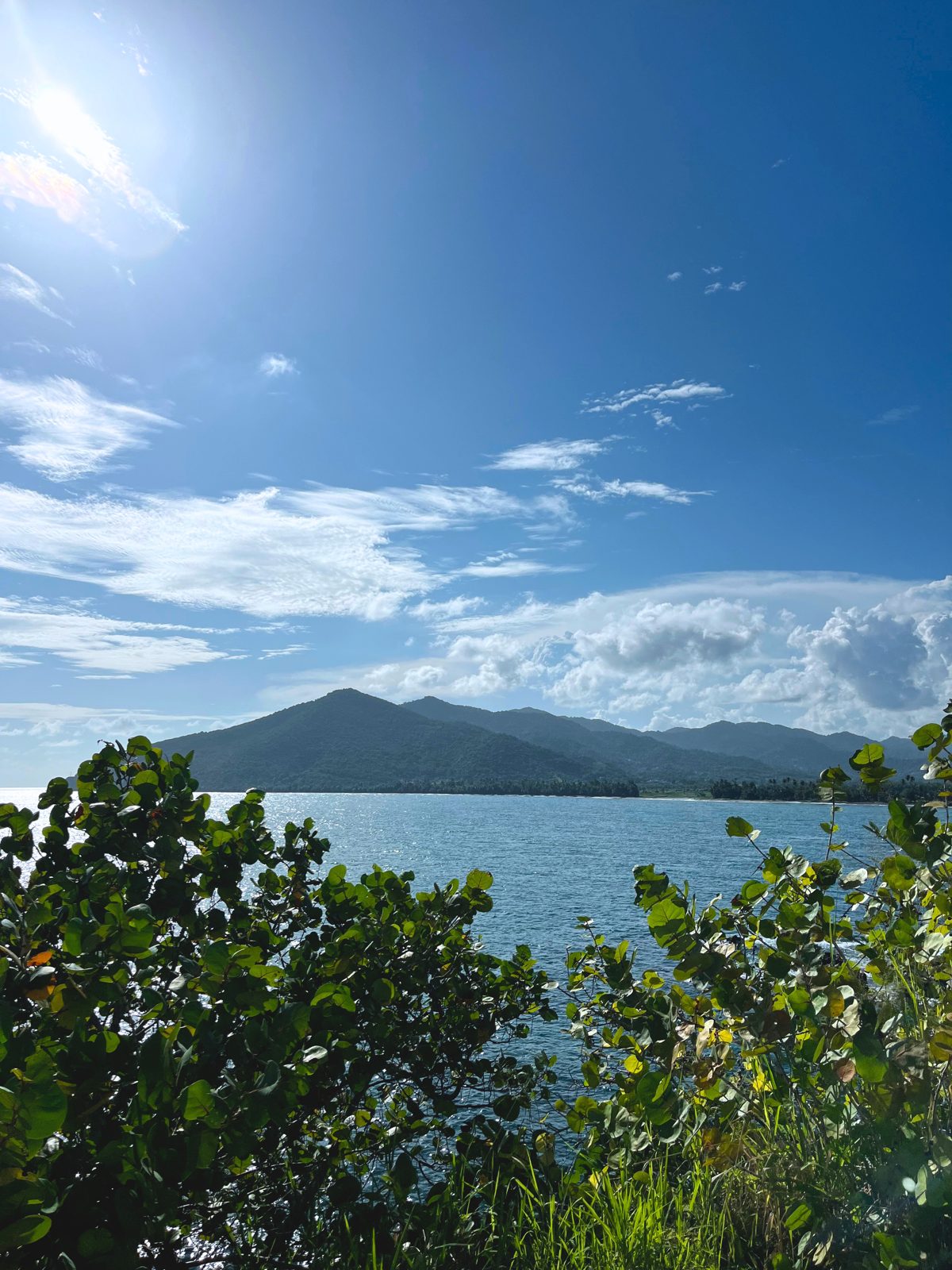 A mountain lake in the island's interior under a wide blue sky